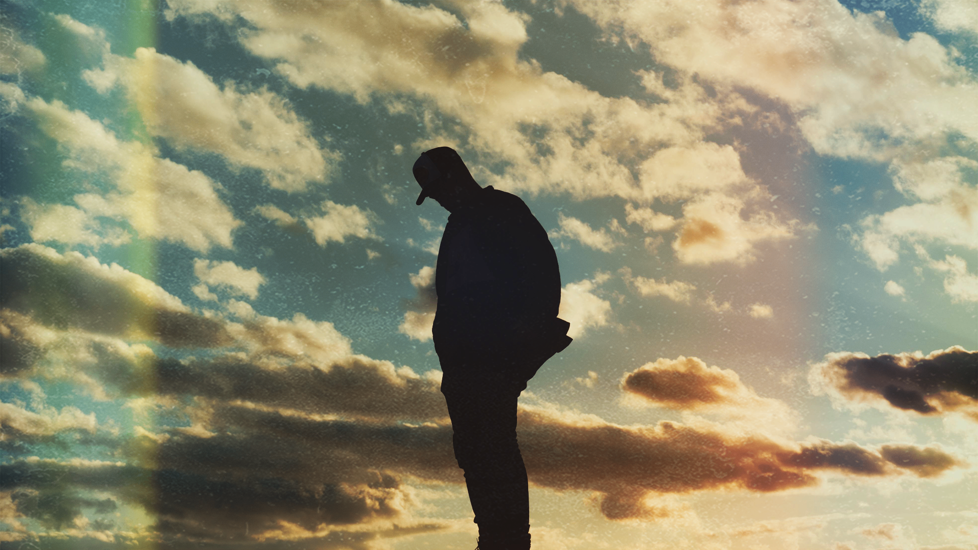 Silhouette against a warm sky of clouds, a quiet moment of reflection